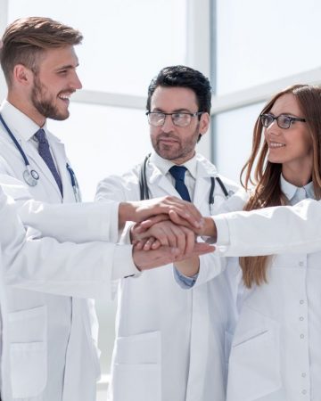 group of doctors with their hands folded together.the concept of health