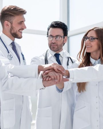 group of doctors with their hands folded together.the concept of health