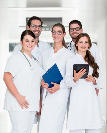 Team of doctors standing in hospital corridor